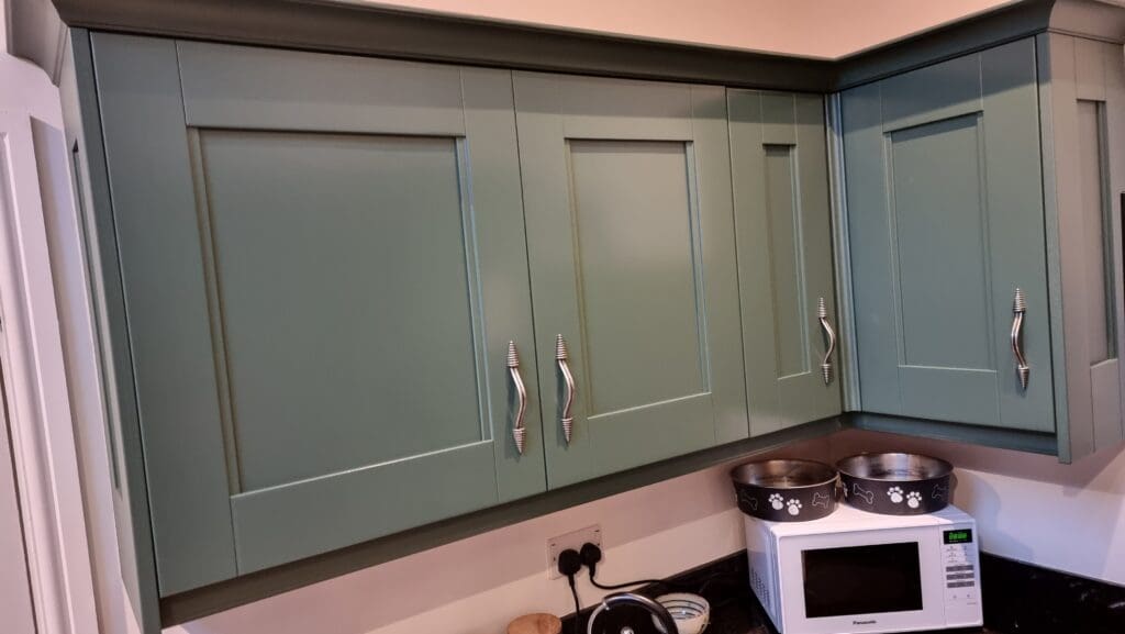 Same kitchen wall cabinets after a heritage green spray finish