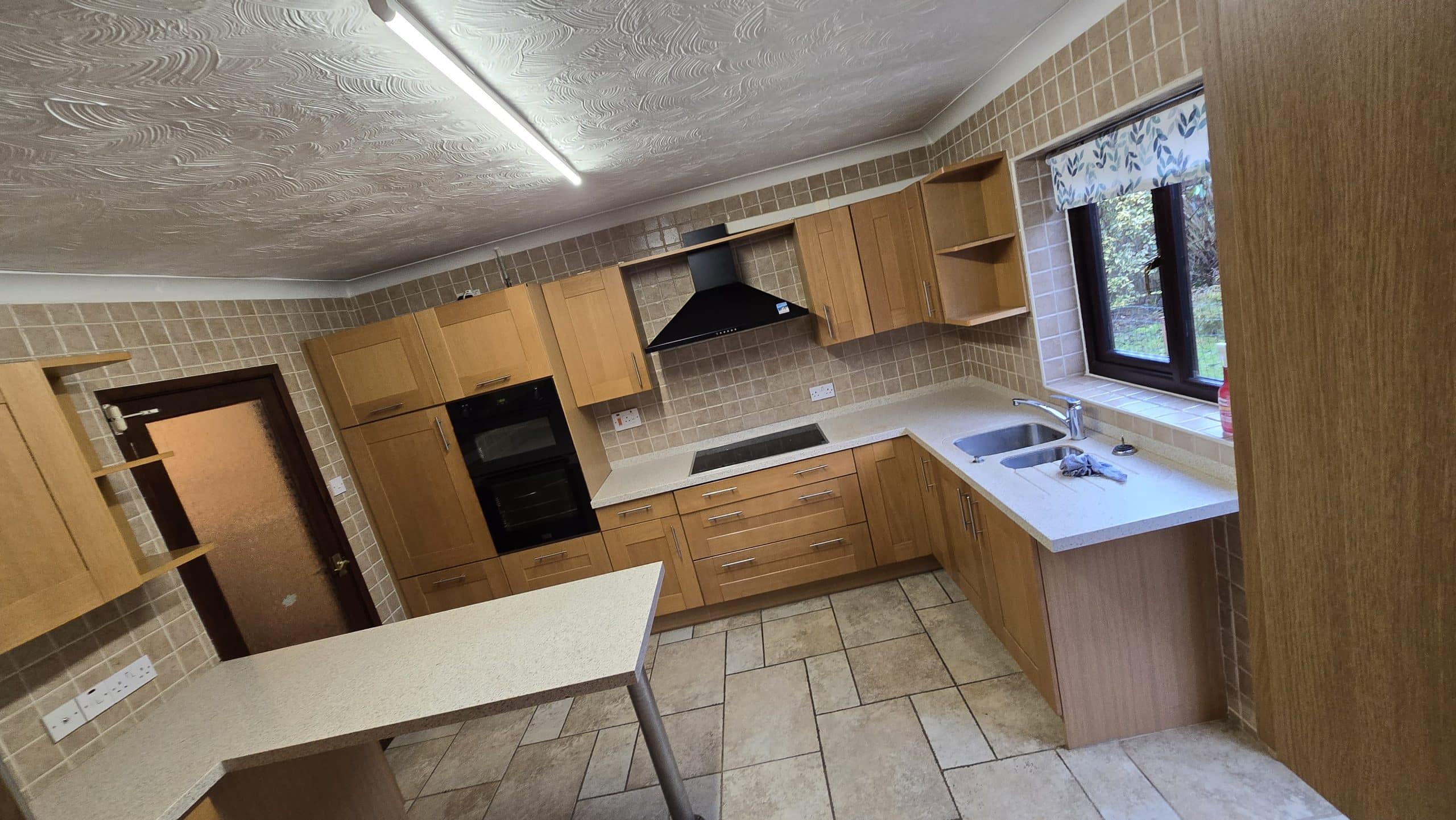 Oak kitchen cabinets before professional spraying by Spray Masters